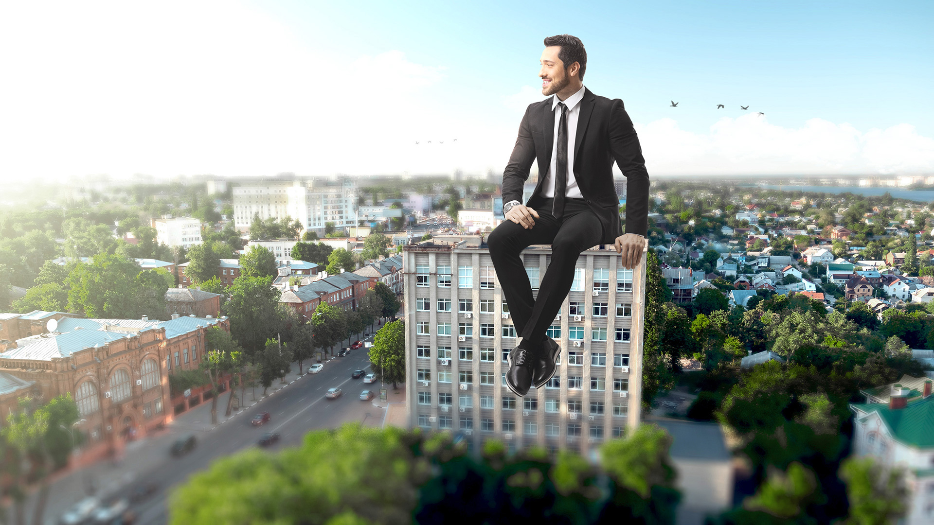 Giant property manager sitting atop an apartment building